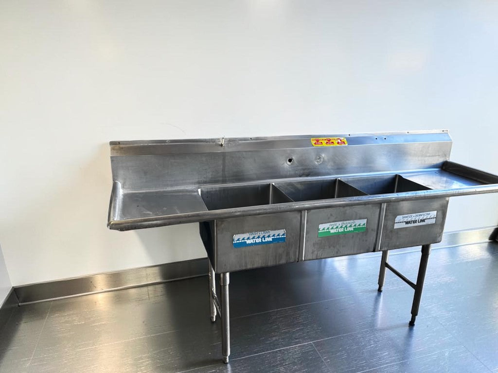 Flawless Condition – Commercial Three-Compartment Stainless Steel Sink – Dual Drainboards – High Backsplash – Adjustable Legs – Fully Inspected & Ready for Installation!