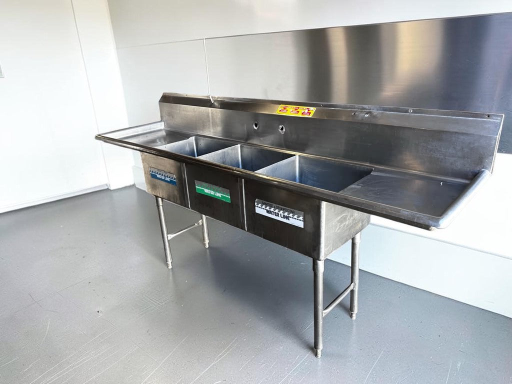 Flawless Condition – Commercial Three-Compartment Stainless Steel Sink – Dual Drainboards – High Backsplash – Adjustable Legs – Fully Inspected & Ready for Installation!